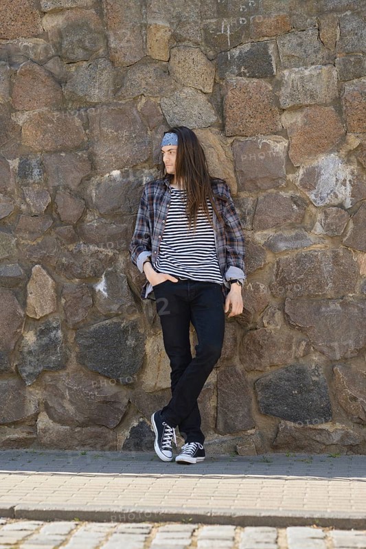 Young long-haired man in plaid shirt