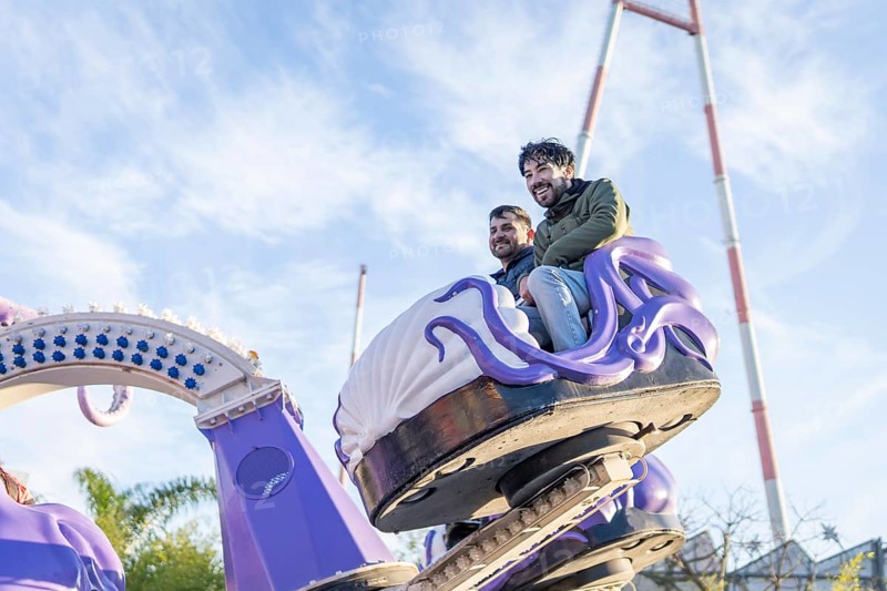 Couple of latin friends having fun in an amusement park
