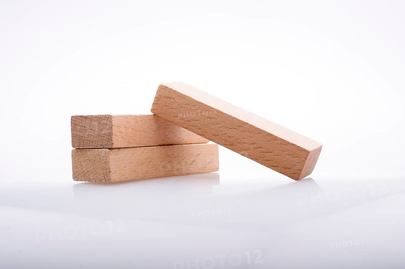 Wooden Domino Blocks in a line on a white background