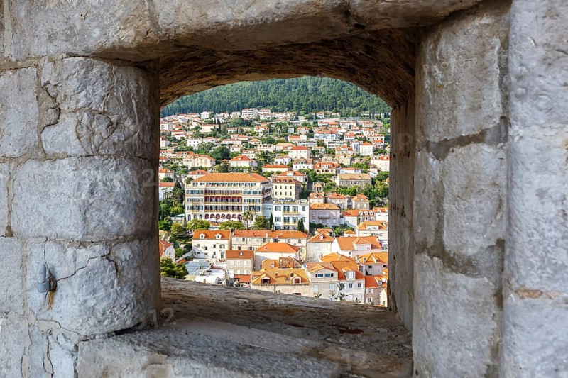 View of the old town through an opening in the wall of the fortress in Dubrovnik