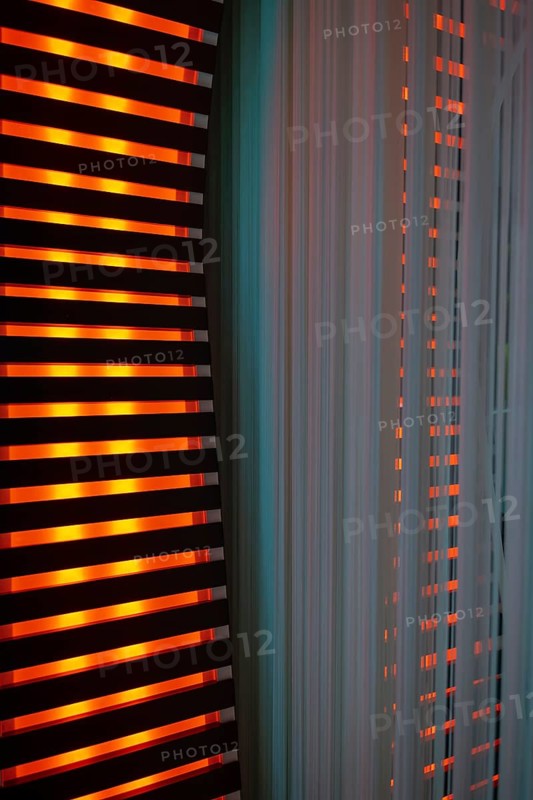 Illuminated Orange Stripes on a Modern Column in Switzerland