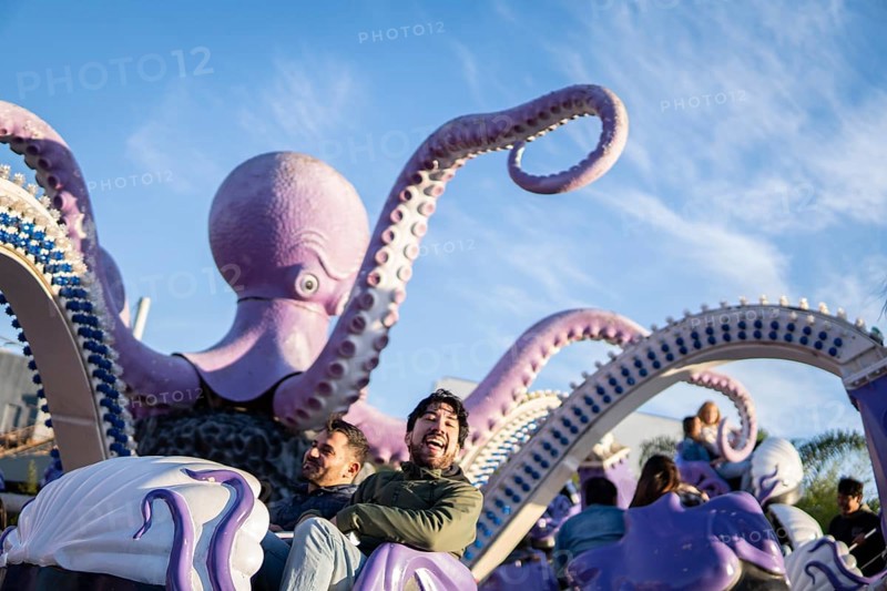 Couple of latin friends having fun in an amusement park