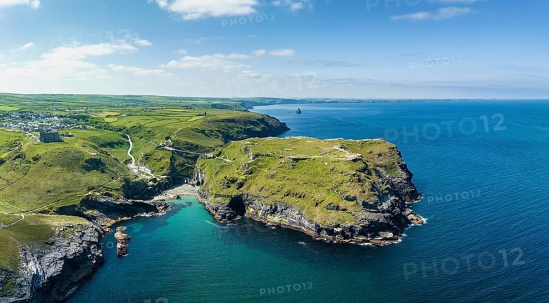 Aerial panorama of the rugged coastline on the Celtic Sea with the Tintagel Peninsula and the ruins of Tintagel Castle
