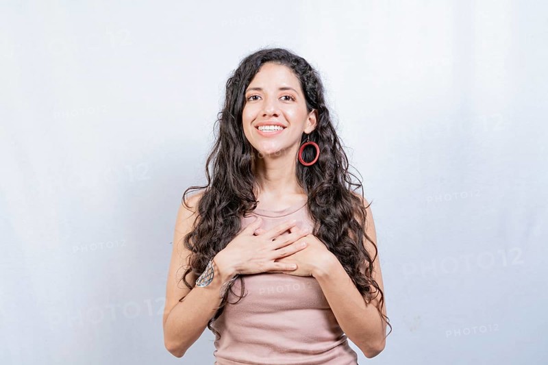 Positive woman with lovely sincere smile feeling thankful