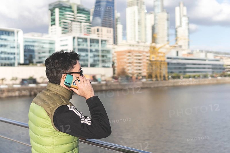 Latin man talking on the phone in Puerto Madero
