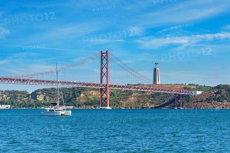 View of 25 de Abril Bridge famous tourist landmark over Tagus river