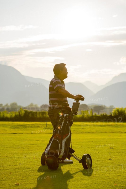 Golfer with his golf bag on the fairway