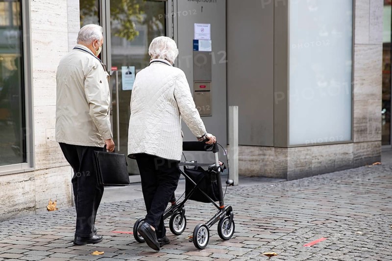 Pensioner with walker in the city centre
