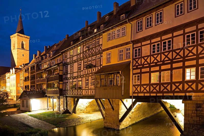 Half-timbered houses of the Kraemerbruecke with the river Gera and the Aegidienkirche in the evening
