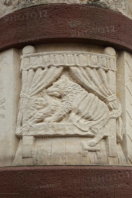 Fairytale fountain with relief of the fairytale Little Red Riding Hood with wolf and bed