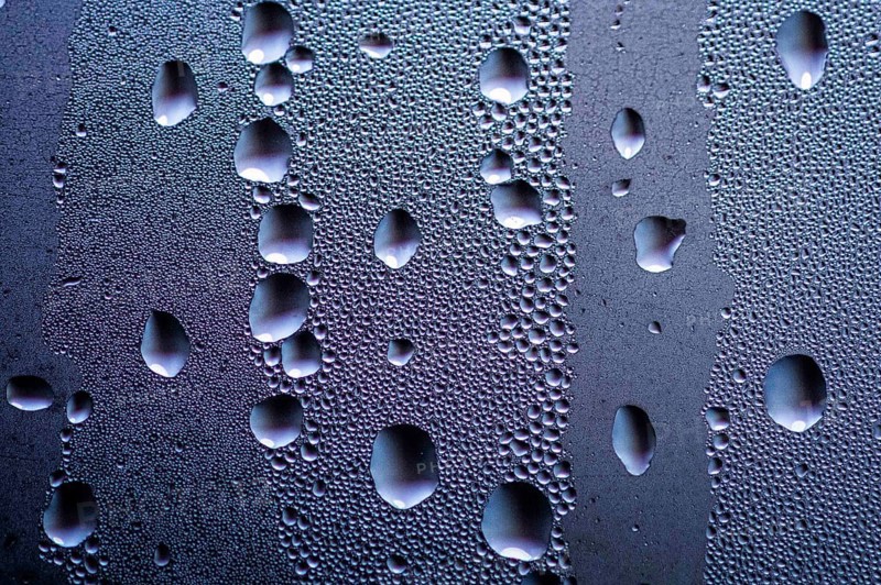 Drops stand out on a window pane in Berlin