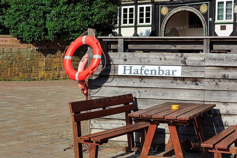 Wooden seating group on terrace of a bar