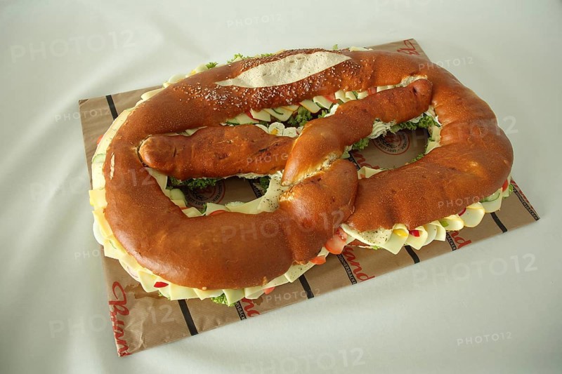 Large pretzel with cheese and sausage