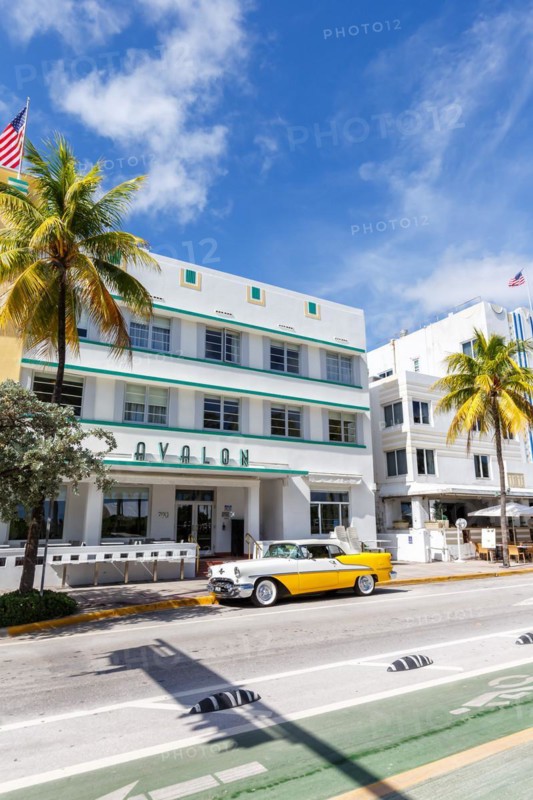 Avalon Hotel in Art Deco style architecture and vintage car on Ocean Drive in Miami Beach