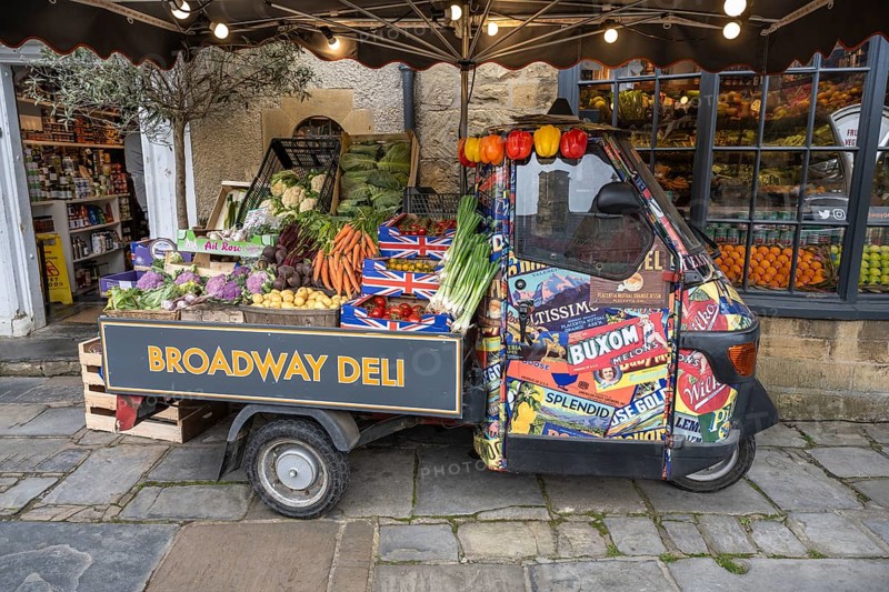 A Piaggio Ape tricycle as a vegetable stall on the high street of Broadway
