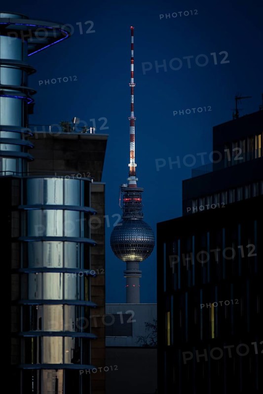 The TV tower looms behind office buildings in Berlin