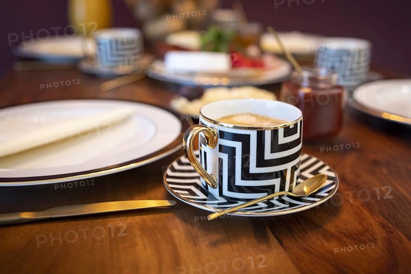 Breakfast with a coffee in a luxurious cup.