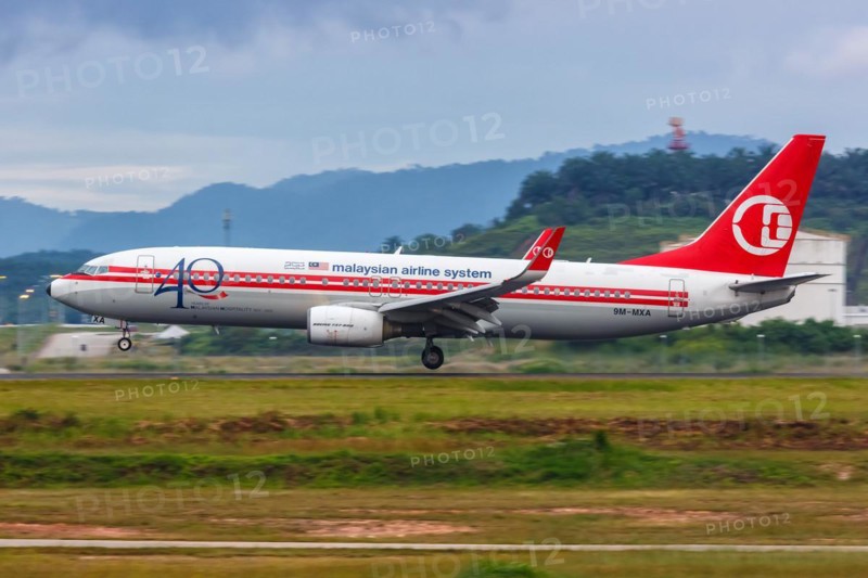 A Malaysia Airlines Boeing 737-800 aircraft with registration number 9M-MXA in retro livery at Kuala Lumpur Airport