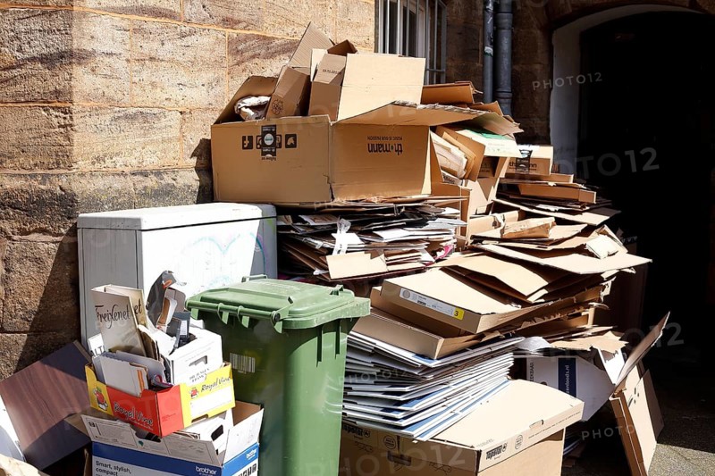 Cartons and stacks of waste paper