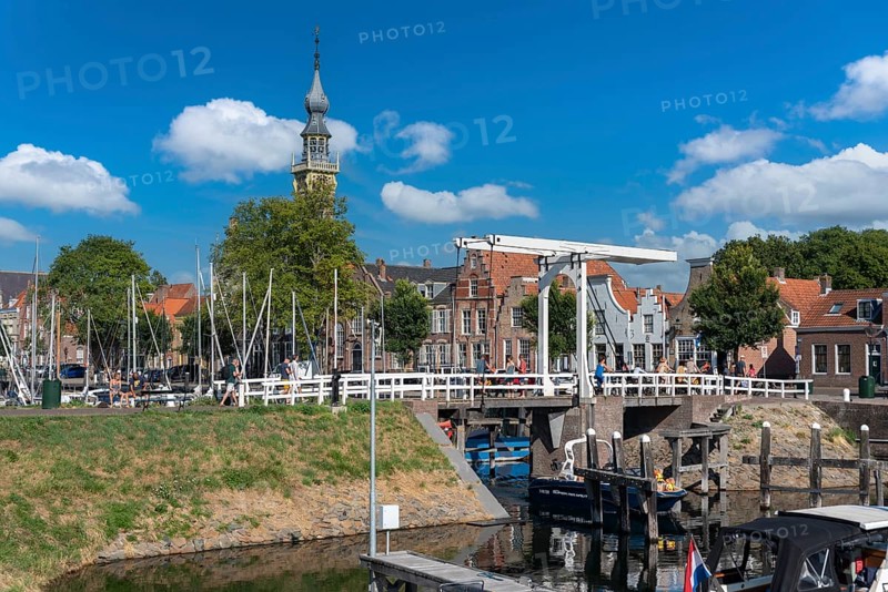Cityscape at the marina with Queen Beatrix Bridge and historic town hall