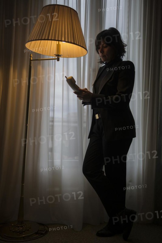 Woman standing close to a window