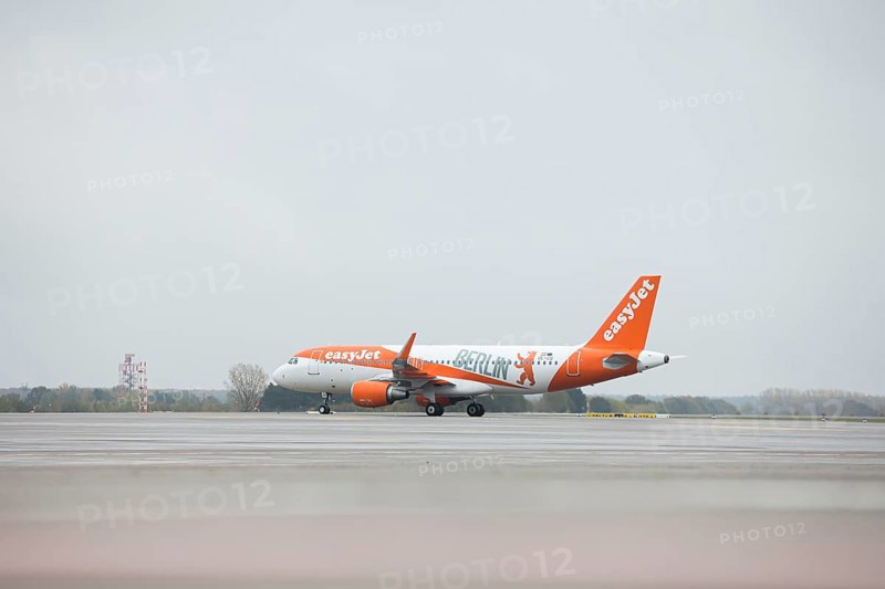 An EasyJet aircraft with the inscription Berlin taxis across the tarmac at BER Airport. Schoenefeld