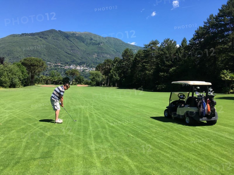 Man with Golf Cart Playing Golf on Golf Course