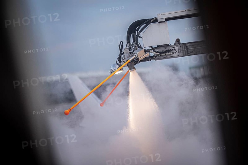 An aircraft is de-iced at Berlin-Schoenefeld BER Airport in Schoenefeld