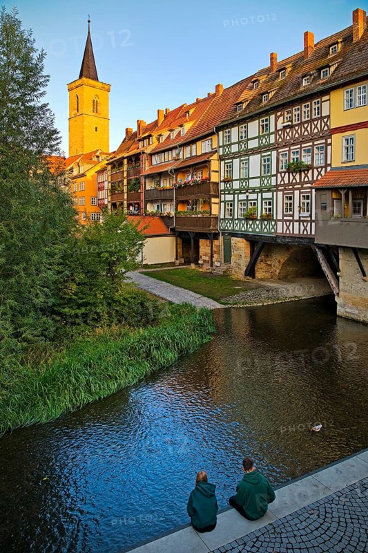 Half-timbered houses of the Kraemerbruecke with the river Gera and the Aegidienkirche