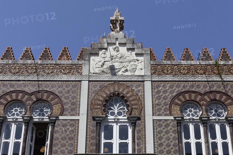 Ceramic tile facade with horseshoe window