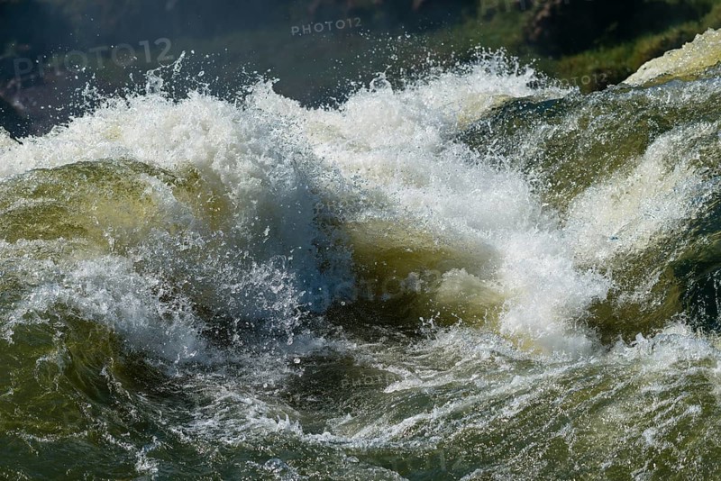 Waterfall plunges into the river