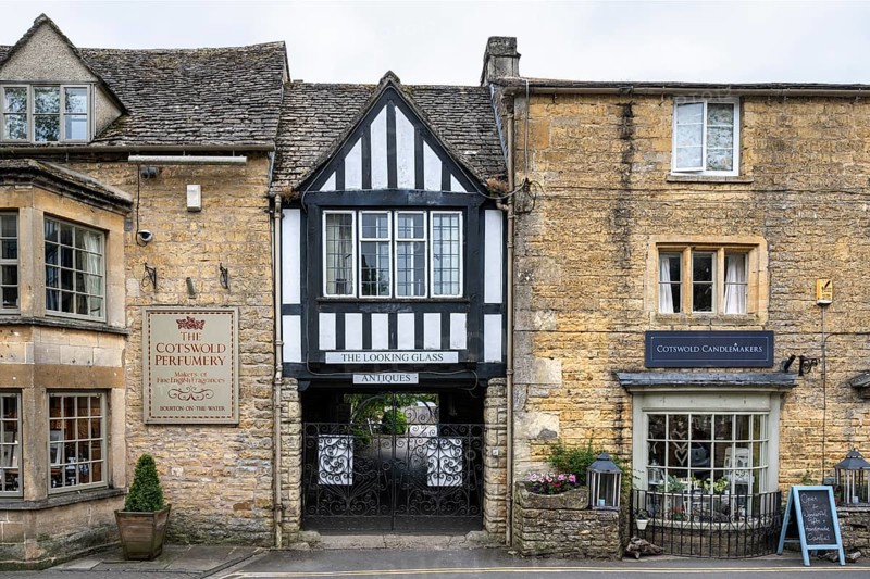 Typical stone houses and half-timbered houses in the Cotswolds with row of shops