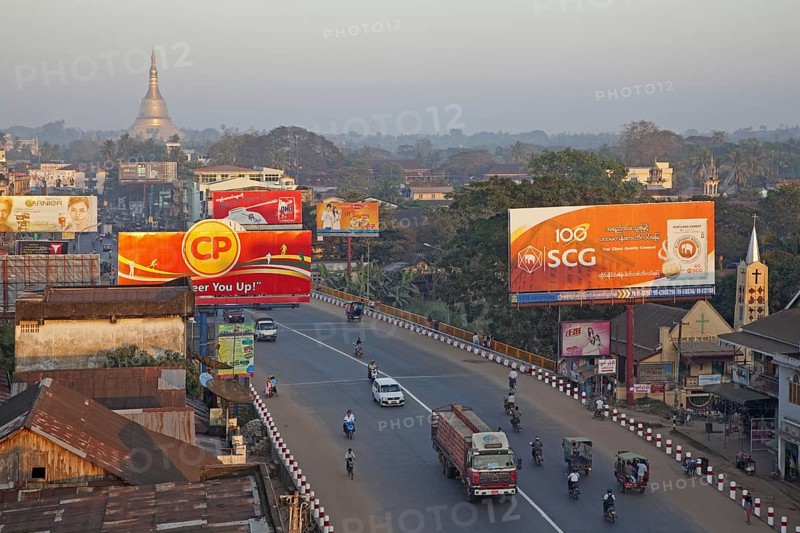 Traffic in street with billboards in the city Bago