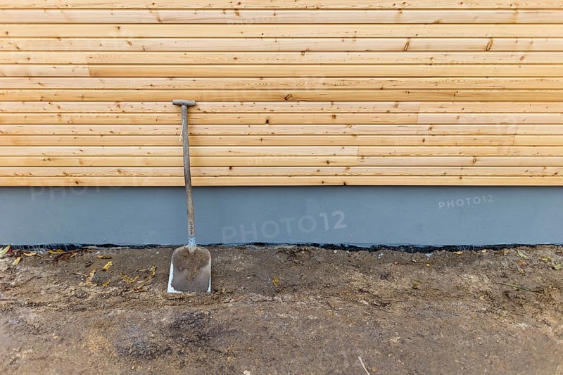 A shovel is leaning against a wall at a construction site. Berlin