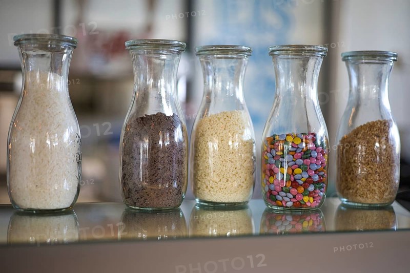 Cereals in decorative bottles in an ice cream parlour
