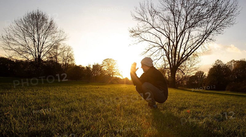 Man stretching in a meadow in autumn. Bonn