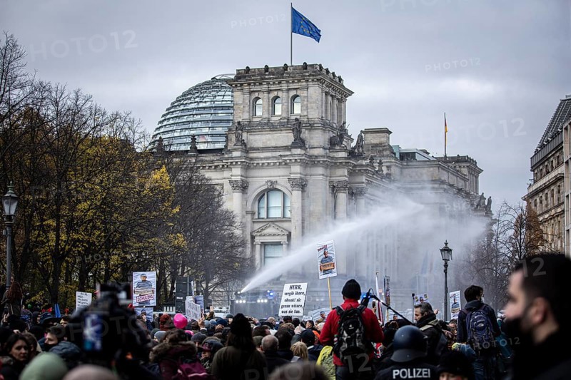 Police officers act with water cannons against demonstrators protesting against the reform of the infection protection law in Berlin