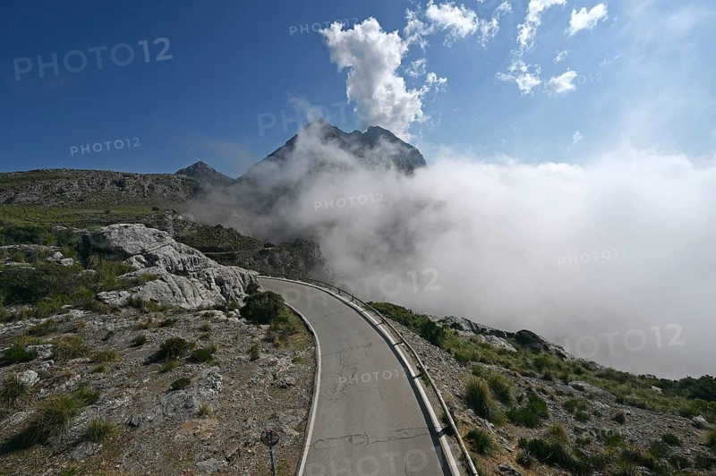 The winding road from Sa Calobra to Coll dels Reis in the Tramuntana Mountains with clouds