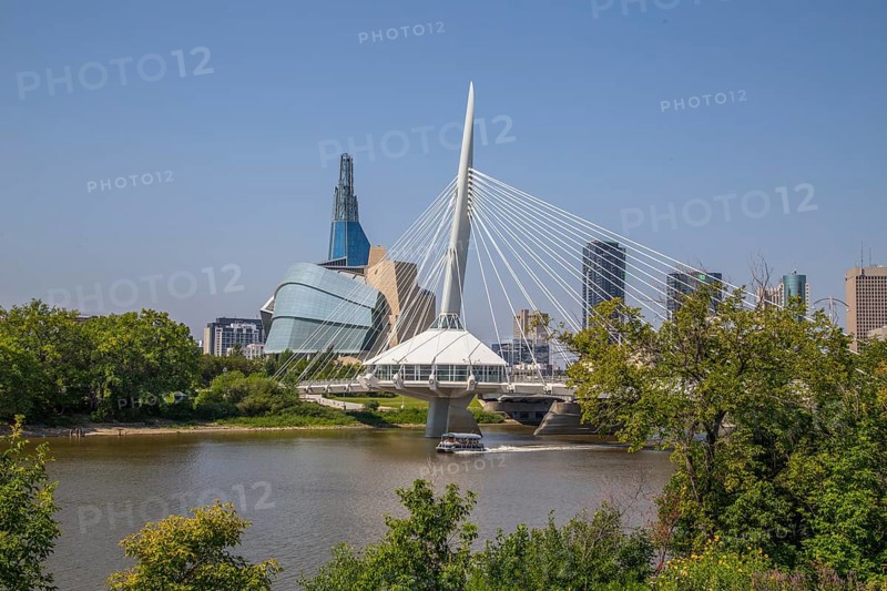 View from the Tache Promenade of the Red River with Provencher Bridge and the Winnipeg skyline behind it