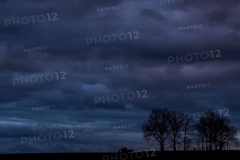 A van stands out at blue hour on a country road in Vierkirchen