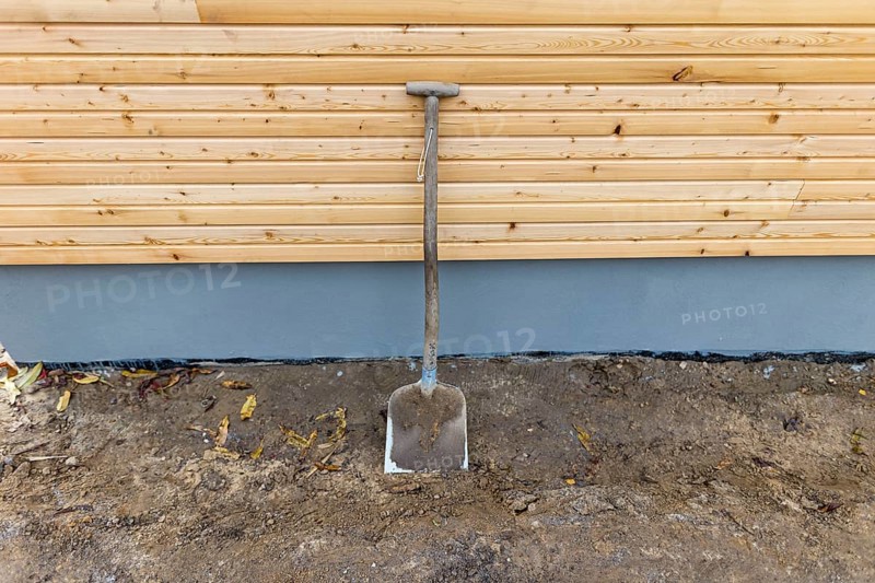 A shovel leans against a wall at a construction site. Berlin