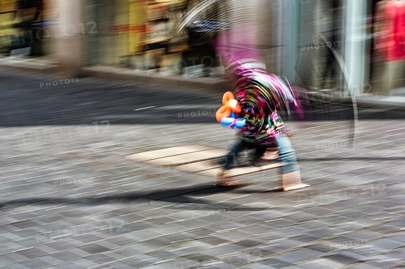 Colourful clown doing a cartwheel