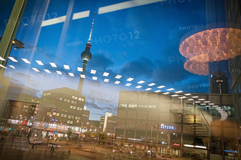 The TV tower at Alexanderplatz is reflected in a disc at blue hour. Berlin