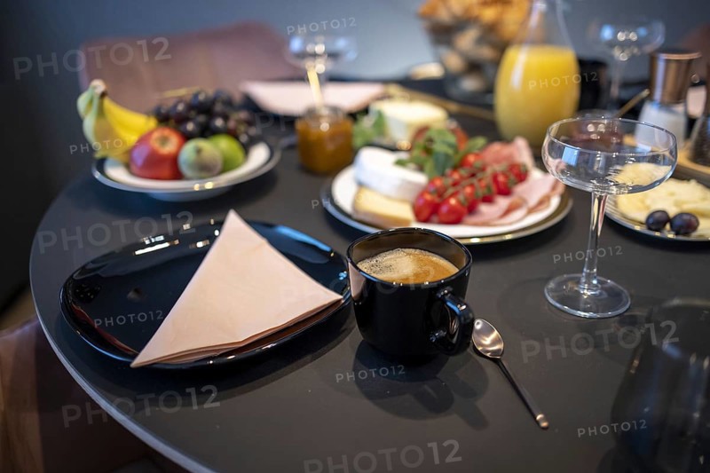 Set dining table with golden cutlery and a cheese and sausage platter