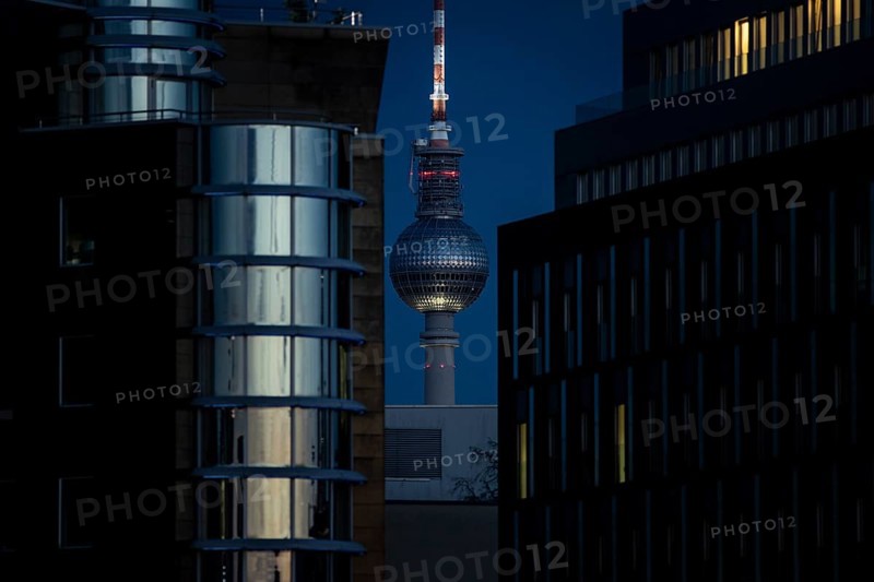 The TV tower looms behind office buildings in Berlin