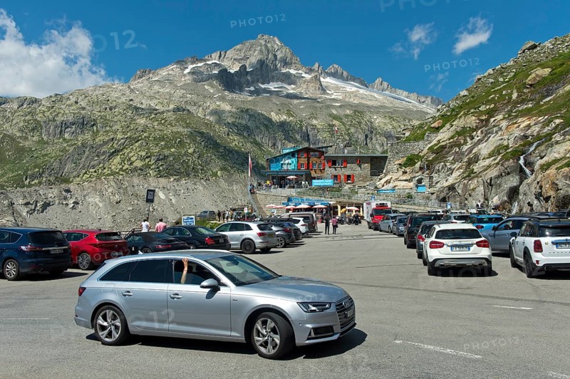 Busy car park at the entrance to the ice grotto in the Rhone glacier