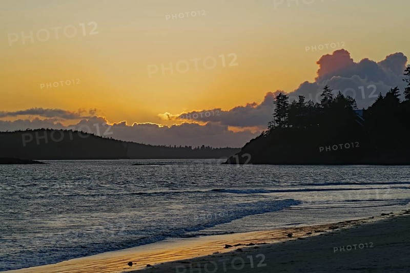Deserted sandy beach at sunset