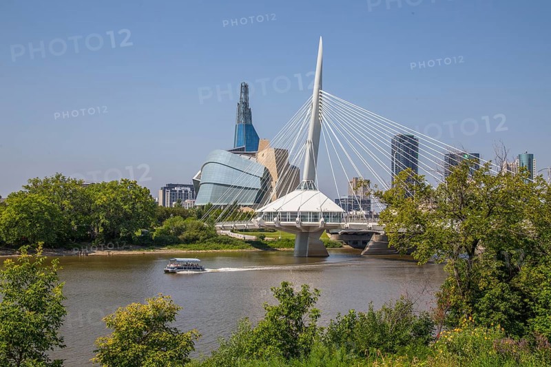 View from the Tache Promenade of the Red River with Provencher Bridge and the Winnipeg skyline behind it