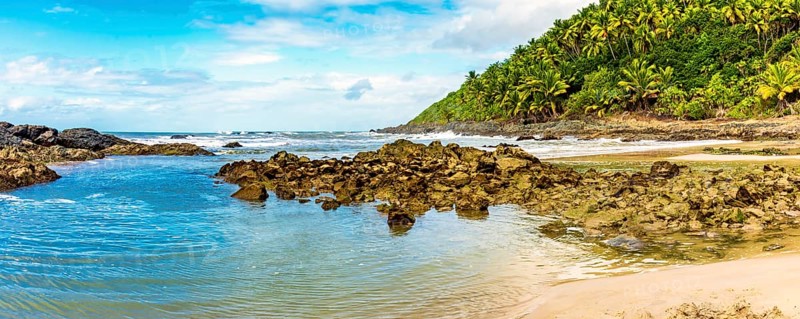 Sea between vegetation and rocks at Prainha beach in Serra Grande on the south coast of Bahia