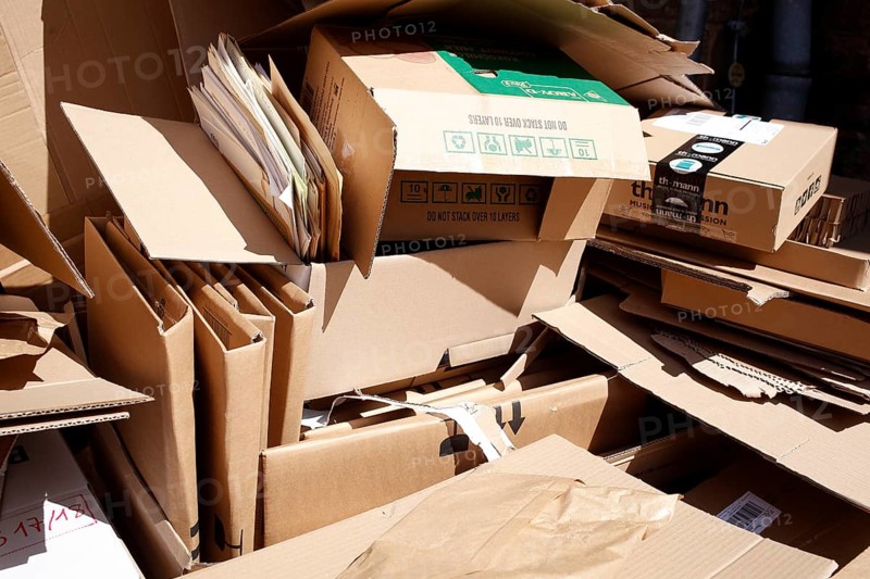 Cartons and stacks of waste paper